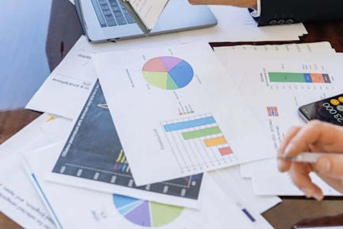 Business professionals discussing financial graphs and charts in an office setting.