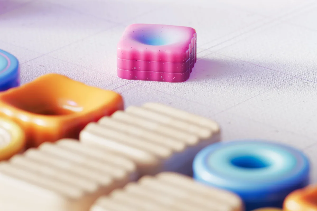 Vibrant colored geometric shapes arranged on a textured abstract surface.