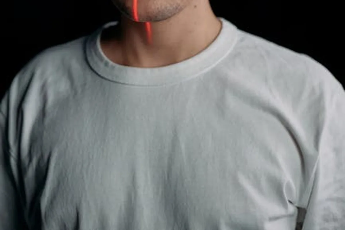 Studio portrait of a man with laser facial recognition technology on black background.
